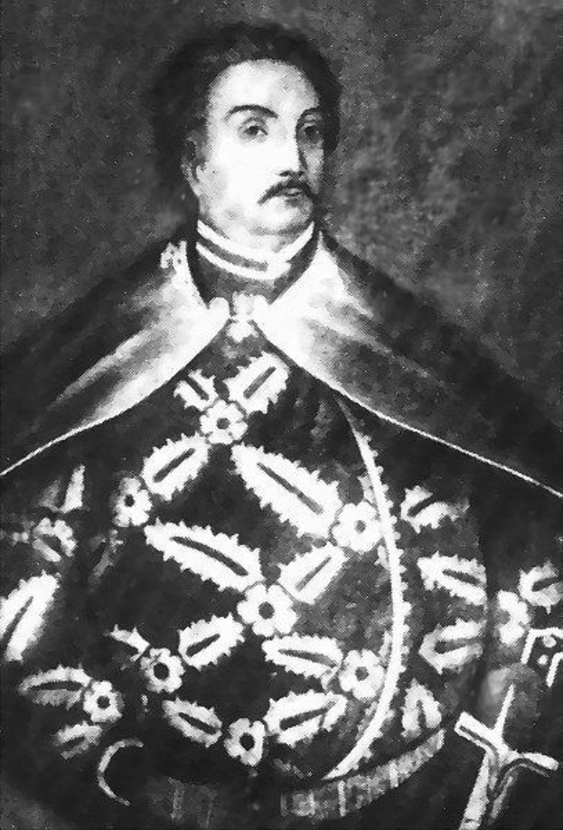 Schwarzes und weißes Foto von Papst Johannes Paul II. in Priesterrobe, der eine schwarze Robe mit weißem Kragen und Manschetten trägt und seine Hände verschränkt, mit einem strengen Gesichtsausdruck und direktem Blick.