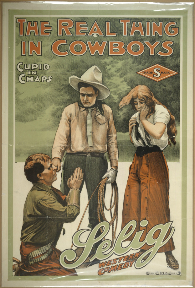Plakat an einer Wand mit drei Personen in Cowboy-Kleidung und "The Real Thing in Cowboys" darüber auf einem hellgelben Hintergrund.