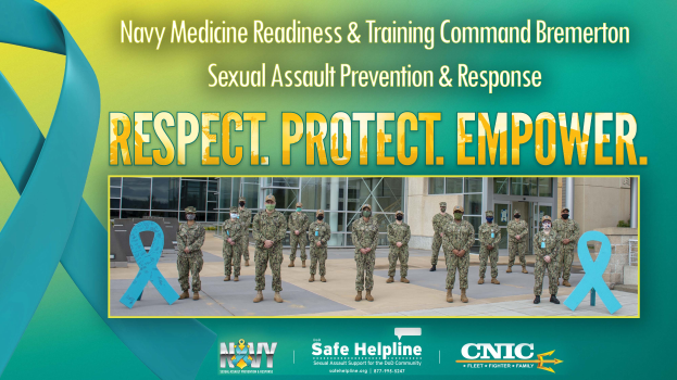 Eine Gruppe uniformierter Personen vor einem Gebäude mit einem Plakat, auf dem "Navy Medicine Readiness & Training Command Bremerton: Sexual Assault Prevention & Response - Respect, Protect, Empower" steht.
